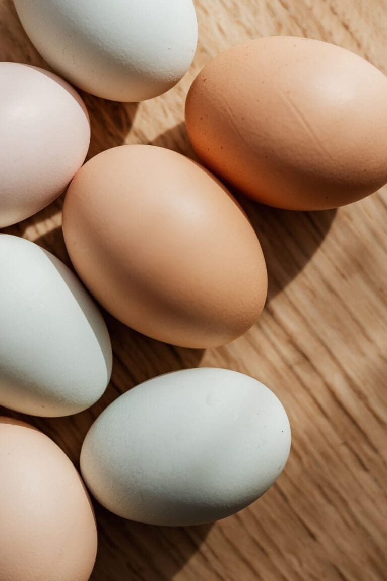 Fresh eggs arranged on a rustic wooden surface_compressed